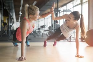 fit woman high five in gym