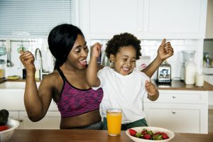 mother eating healthy with child post-workout snack
