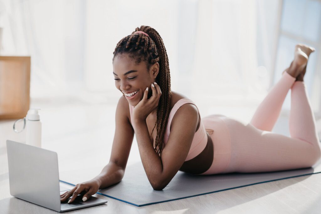 black woman participating in yoga for beginners with Erica Rascon