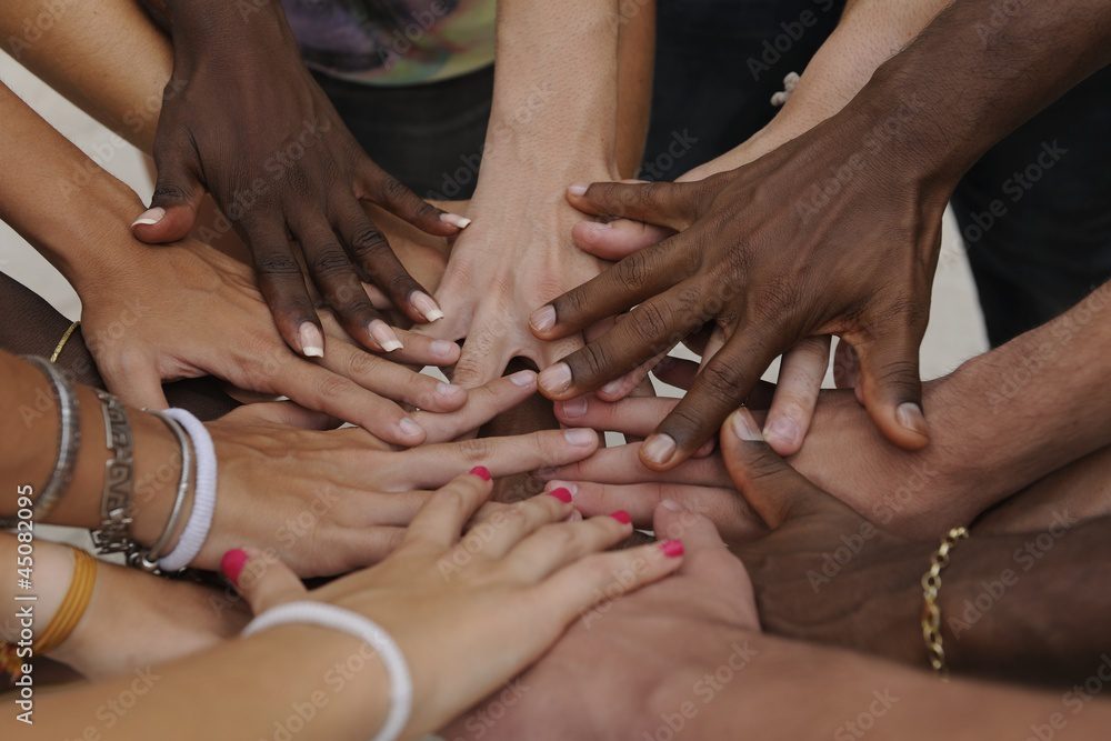 diverse people unite hands to represent unity in yoga