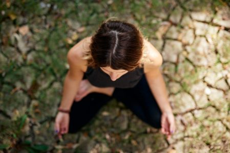woman practicing trauma-conscious yoga with Erica Rascon