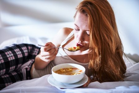 red haired woman trying to improve immune system with nutritious food